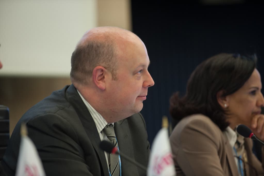 AI governance workshop participants discussing policy at a conference table